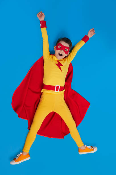 istock Cheerful superhero child in costume in studio 1398204411