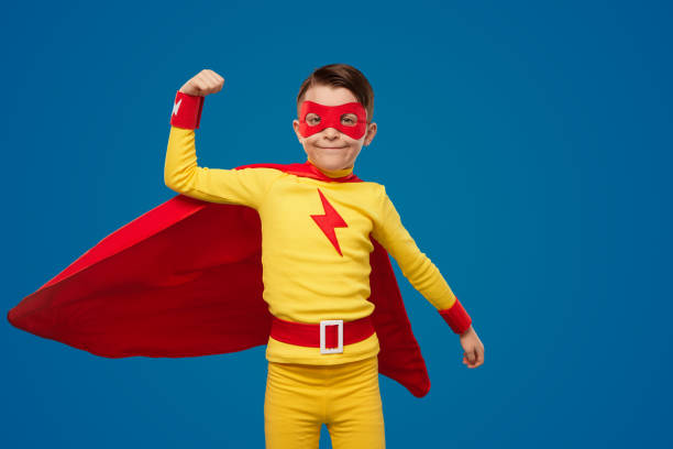 istock Strong superhero boy showing muscles in studio 1398204412