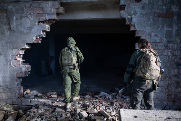Military invasion. Soldiers in bombed building during invasion. 2022 russian invasion of ukraine stock pictures, royalty-free photos & images