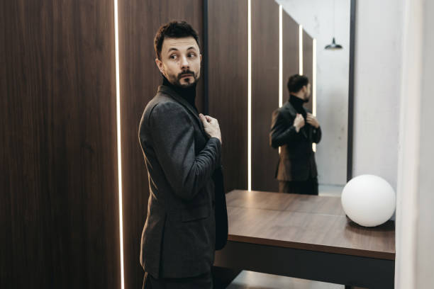 istock handsome man in suit near mirror 1398211299