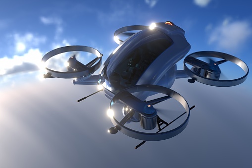 A generic white electric powered Vertical Take Off and Landing eVTOL aircraft with four rotors, coming in to land on roof top helipad with high city city buildings in the background. The sky is bright with clouds and it's late afternoon / early morning.