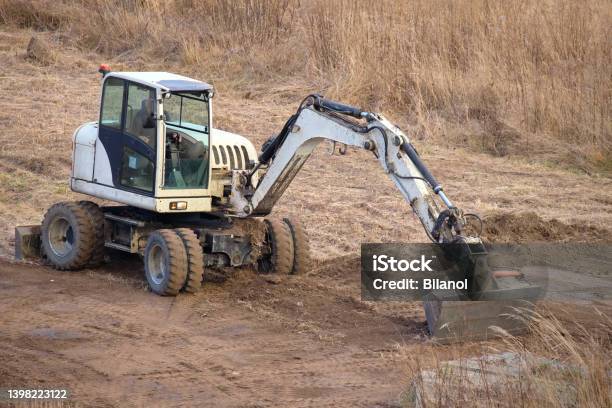 Earth Moving Tractor Preparing Place For Future House Foundation Construction Leveling Soil For Building New Home Stock Photo - Download Image Now