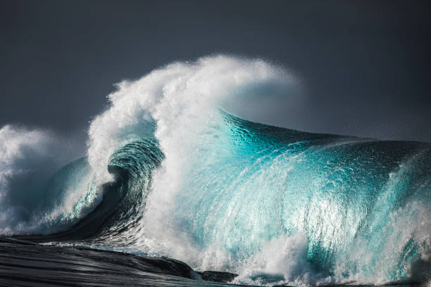 istock Powerful blue reef wave breaking with stormy dark skies 1398224225