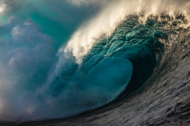 istock Powerful blue open ocean wave barrelling in warm morning light 1398225211
