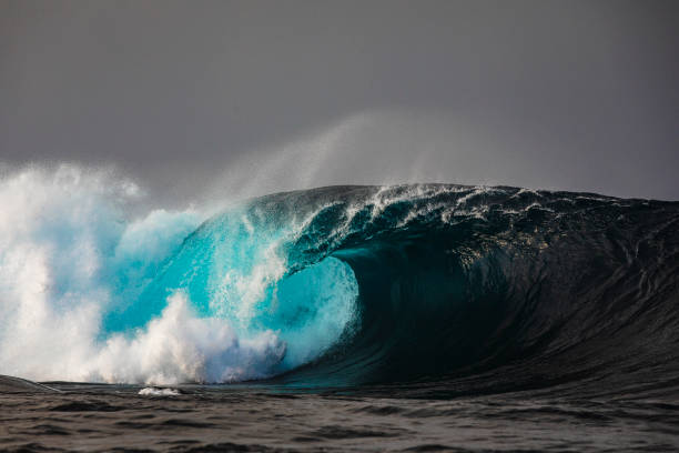 istock Perfect open ocean wave barrelling in dark stormy background 1398225215