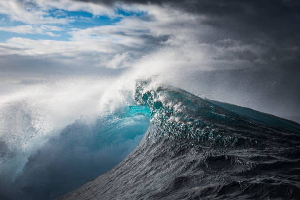 istock Bright blue open ocean wave twisting as it collides with energy in the open ocean 1398225284