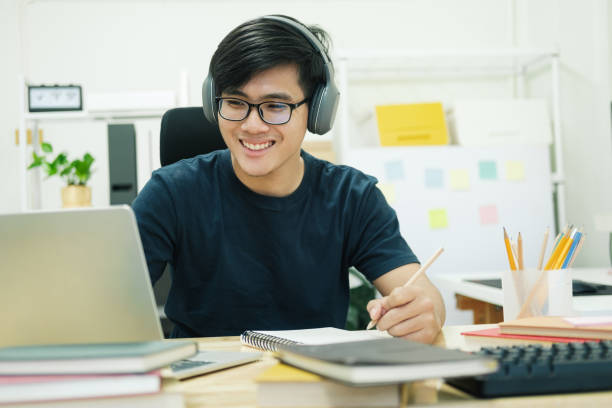 istock Young man study in front of the laptop computer at home 1398227581