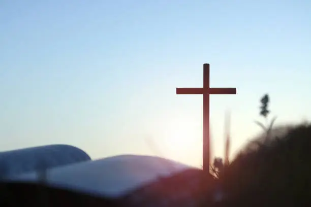 Photo of Shining holy cross of Jesus Christ and bible