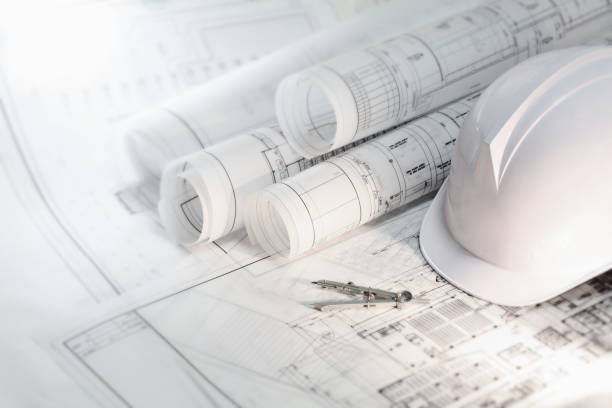 Hard hat and compass on architectural blueprints and construction technology and future industry Architect's helmet and compass on architectural blueprints and construction technology and future industry blueprint stock pictures, royalty-free photos & images