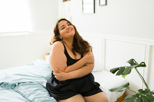 Acceptance concept. Beautiful overweight woman promoting body positivity and diversity