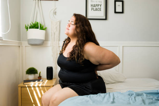 istock Sad woman stretching because of back pain 1398230413