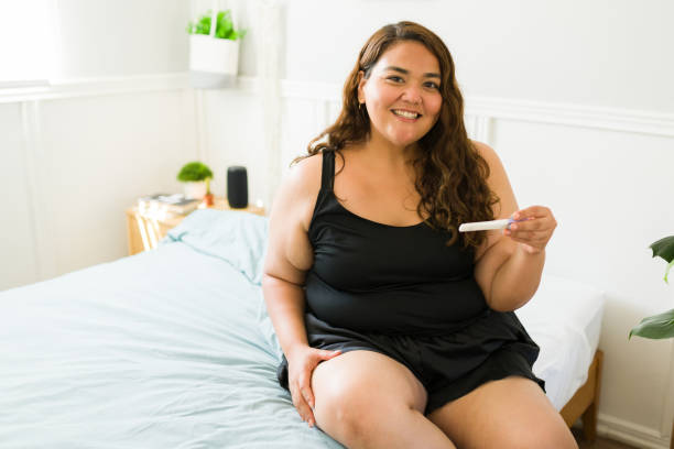 Excited pregnant overweight woman stock photo