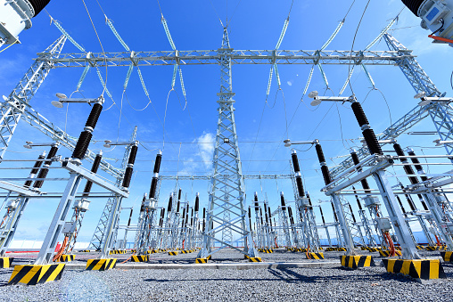 Electric High Voltage Power Substation With Transformers: Electricity Substation, Power Line, Power Station, Cable Under The Bluesky Background Generating Renewable Energy To Reduce Global Warming and Climate Change and support earth day movement