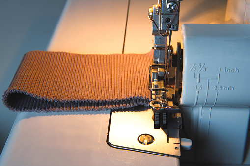 Sewing process on an overlock machine - macro shot. Selective focus
