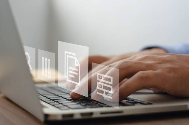 istock Businessman using computer to manage ERP documents in document management concept with icons on virtual screen. 1398236829