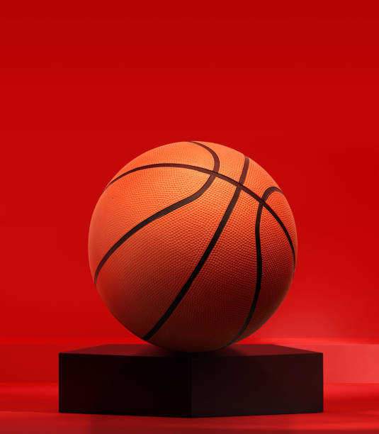 Basketball on black pentagon podium in the red studio Basketball on black pentagon podium in the red studio college basketball court stock pictures, royalty-free photos & images