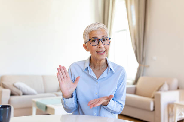 istock Senior woman on video call with her student,explaining with her hands.Online teaching, business concept 1398238743