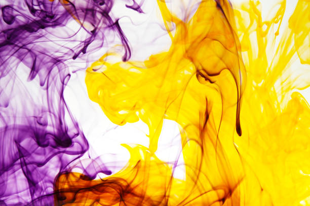 Abstract Soft Focus Orange And Purple Ink flowing In Water On White background.