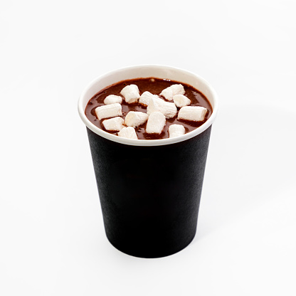 A paper cup with hot cocoa and marshmallows to take away. Close-up, on a white background.
