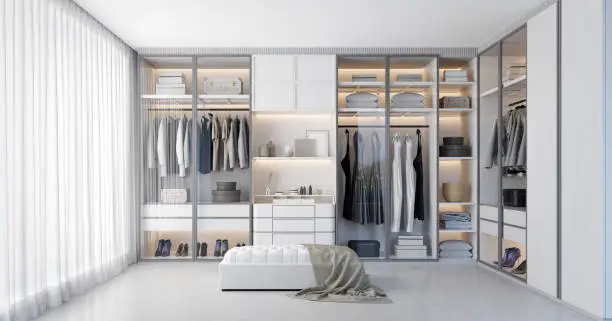 Photo of White luxury walk in closet interior with light frome the window.3d rendering