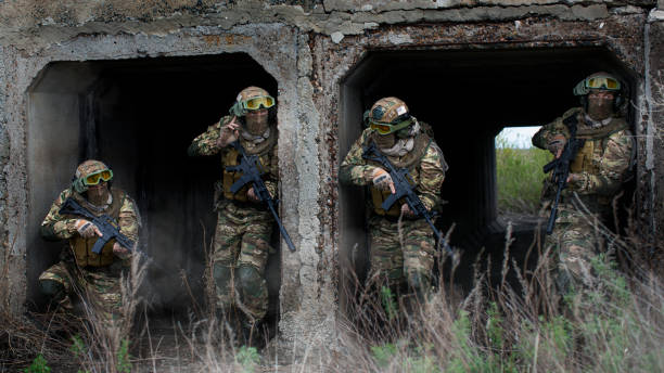 istock Four special forces soldiers during a special operation at the exit from the tunnel. 1398241611