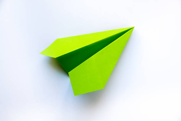 istock Green paper plane origami isolated on a white background 1398243328
