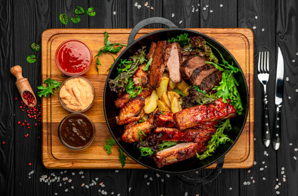 istock Different barbecue meat with potatoes in a frying pan 1398243411