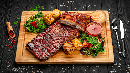 BBQ ribs with sweet and sour sauce, served with roasted corn