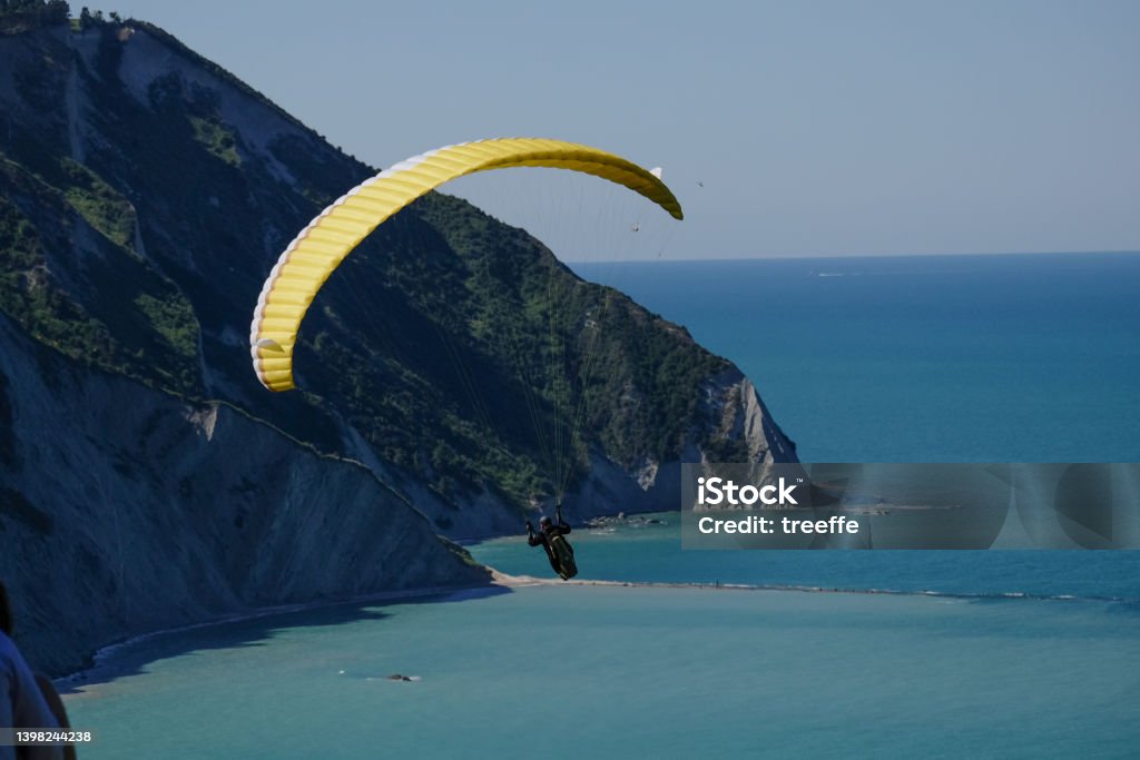 Paraglind in riviera del conero Portonovo with its high cliff is a perfect place for Paragliders Paragliding Stock Photo