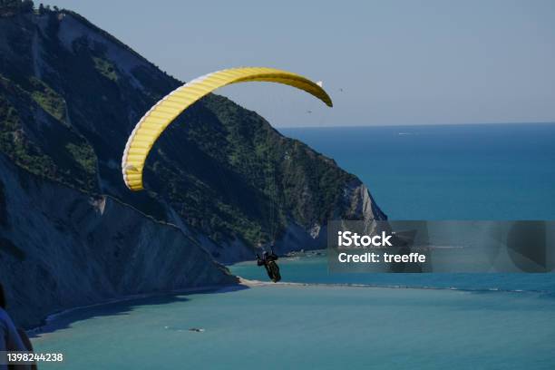 Paraglind In Riviera Del Conero Stock Photo - Download Image Now - Paragliding, Adriatic Sea, Bay of Water
