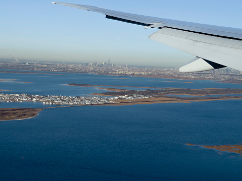 A photograph from the cabin of an aircraft about to land at John F. Kennedy International Airport in southeastern New York City. through southern Manhattan