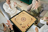 istock Competitors applauding move by carrom player 1398245704