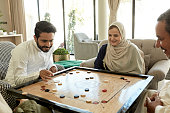 istock Family members playing carrom during domestic competition 1398245711