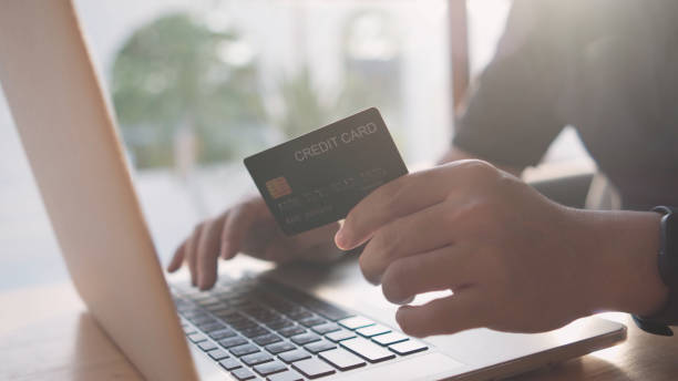 istock Hands typing on a laptop keyboard. to enter credit card information. 1398248435