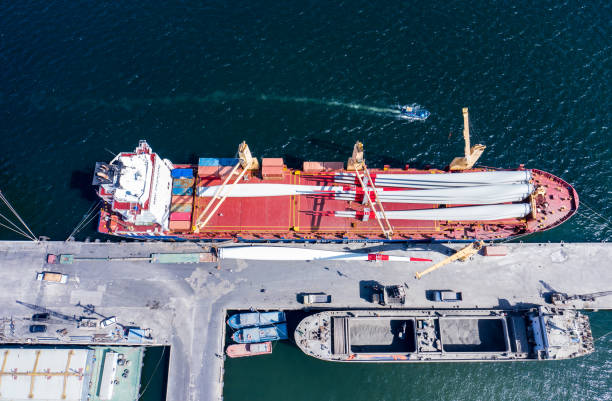 istock Container ship at industrial port in business logistic export import concept. Containers and wind turbine parts in cargo freight ship with industrial crane. 1398249118