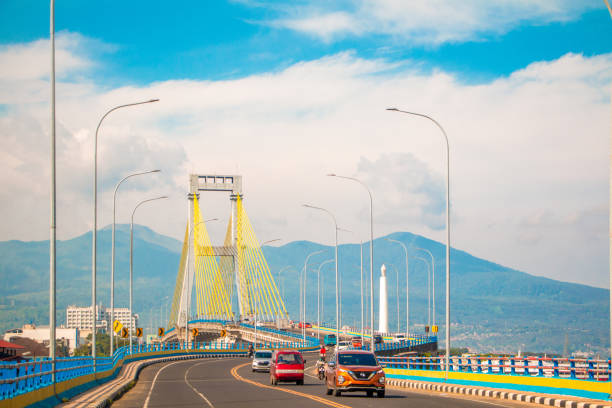 landscape photo of the bridge of the pride of the people of Manado city and with the background of the Minahasa mountains