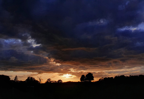 Clouds and horizon under dark sky