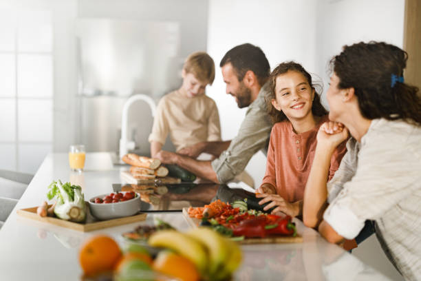 istock Family cooperating while making a meal in the kitchen. 1398254196