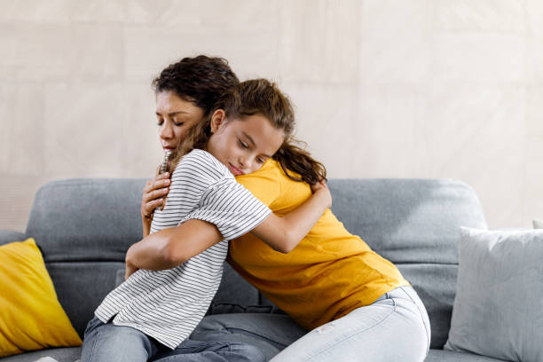 istock Single mother consoling her sad daughter at home. 1398254255