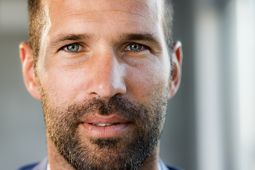 Close up of mid adult man looking at camera.