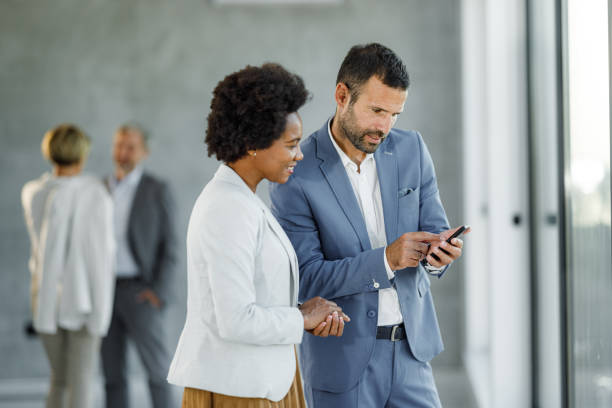 istock Business colleagues using cell phone in the office. 1398255518