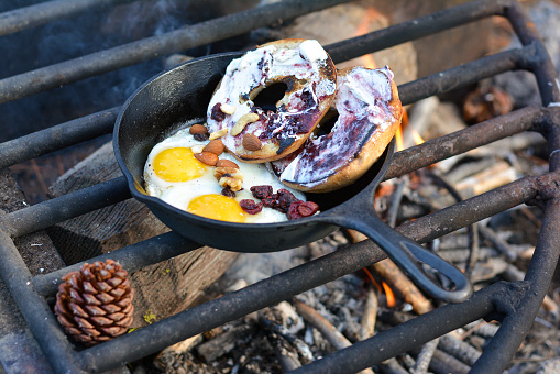 breakfast on the camp fire with sunny side up eggs and bagels