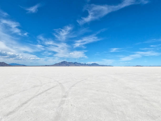Bonneville Salt Flats in the foreground, mountains background, and a blue sky with clouds Bonneville Salt Flats in the foreground, mountains background, and a blue sky with clouds bonneville salt flats stock pictures, royalty-free photos & images