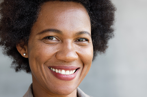 Close up of happy black woman looking at camera.