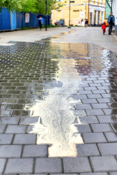 istock Yellow pollen on the sidewalk and people walking on it 1398256820