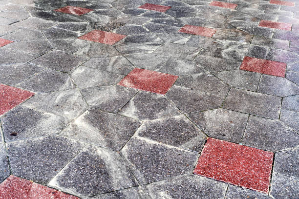 istock Yellow pollen in the water on the sidewalk. 1398256842