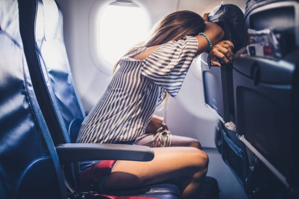 istock Woman taking a nap during the flight in a plane. 1398256880