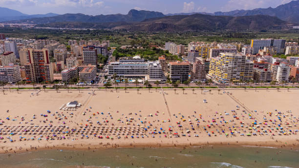 drohnenblick auf die skyline und den strand von gandia - tree large group of people sand sunbathing stock-fotos und bilder