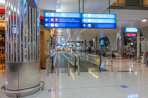 Wide image of busy Dubai International Airport Departure Terminal.