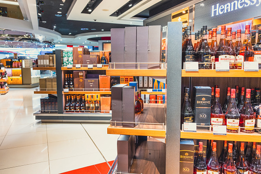 Dubai, UAE - April 27 2020: Image showing varied selection of wine, sprit and other alcohol can be bought at Dubai Duty Free store. Dubai International Airport Terminal, one of the busiest airports in the world. The airport terminal has all the required modern amenities such as restaurants, retail space, gaming arcades, prayer rooms, relaxation facilities such as spa and hotels.